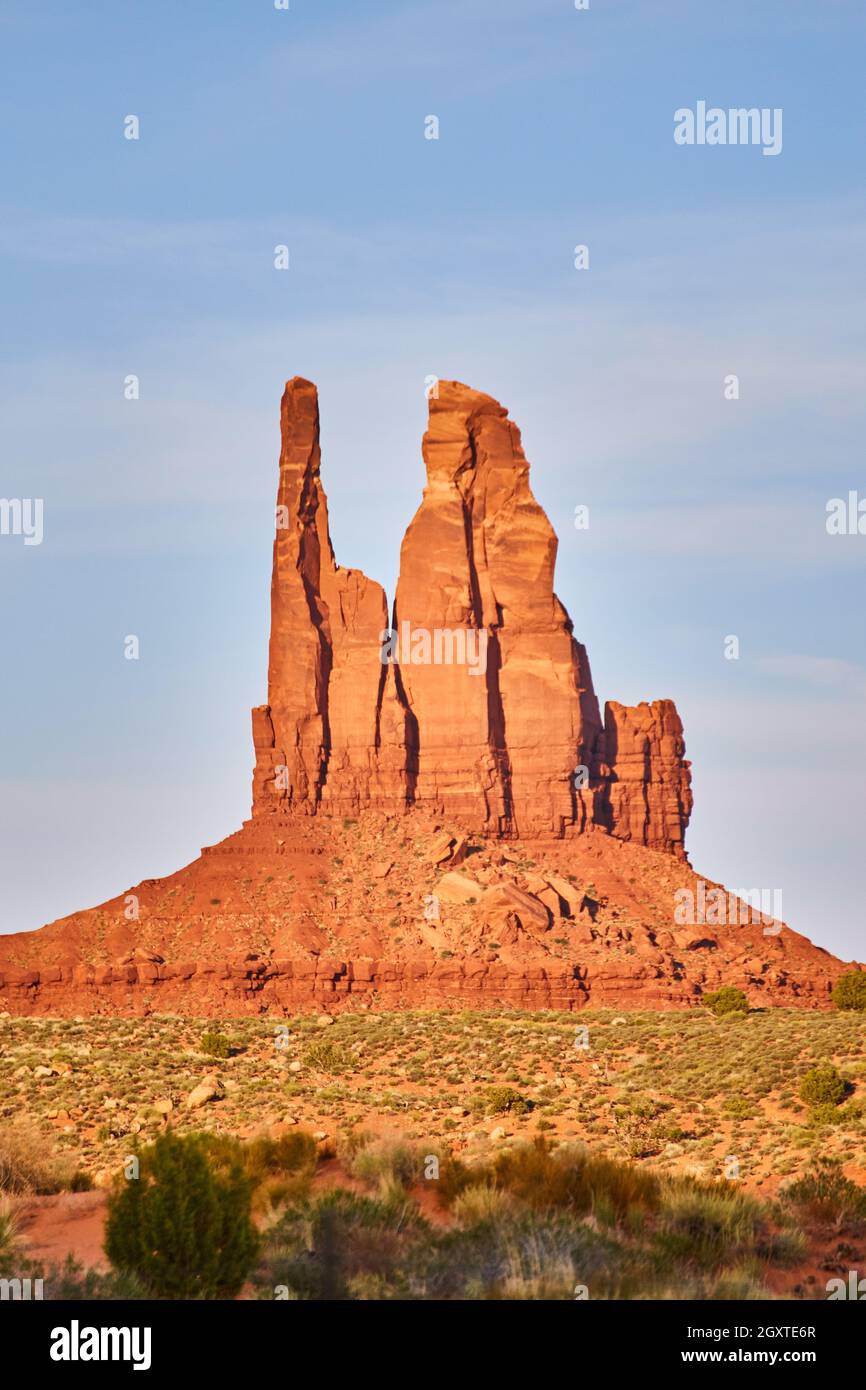 Vertical large red rock pillar in desert with blue sky Stock Photo Alamy