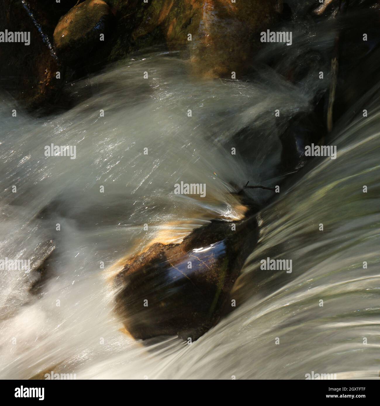 Clear water of a river flowing over a rock Stock Photo - Alamy