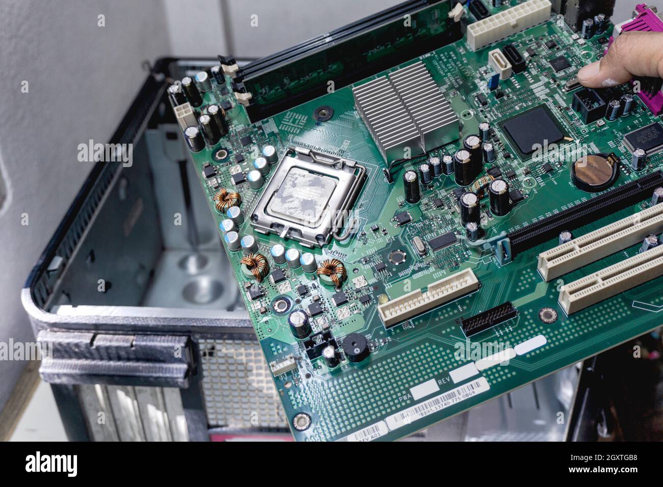 The technician holds a board computer pc for the upgrade to repair inside The socket motherboard or equipment. Computer upgrade center concept Stock Photo