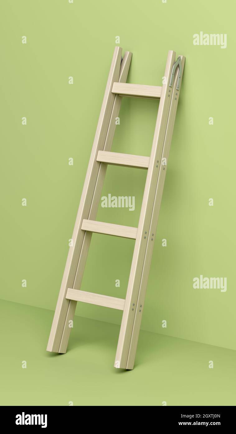Wood double step ladder leaning against the green wall Stock Photo
