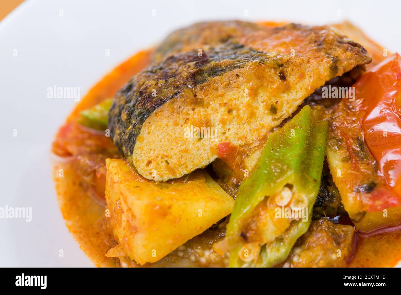 Close up view of Malay style spicy vegetarian assam fish head. Stock Photo