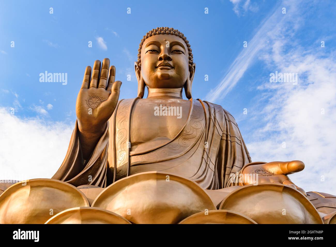 Giant Buddha statue with blue sky at Zhengjue Temple, Jilin, China Stock Photo