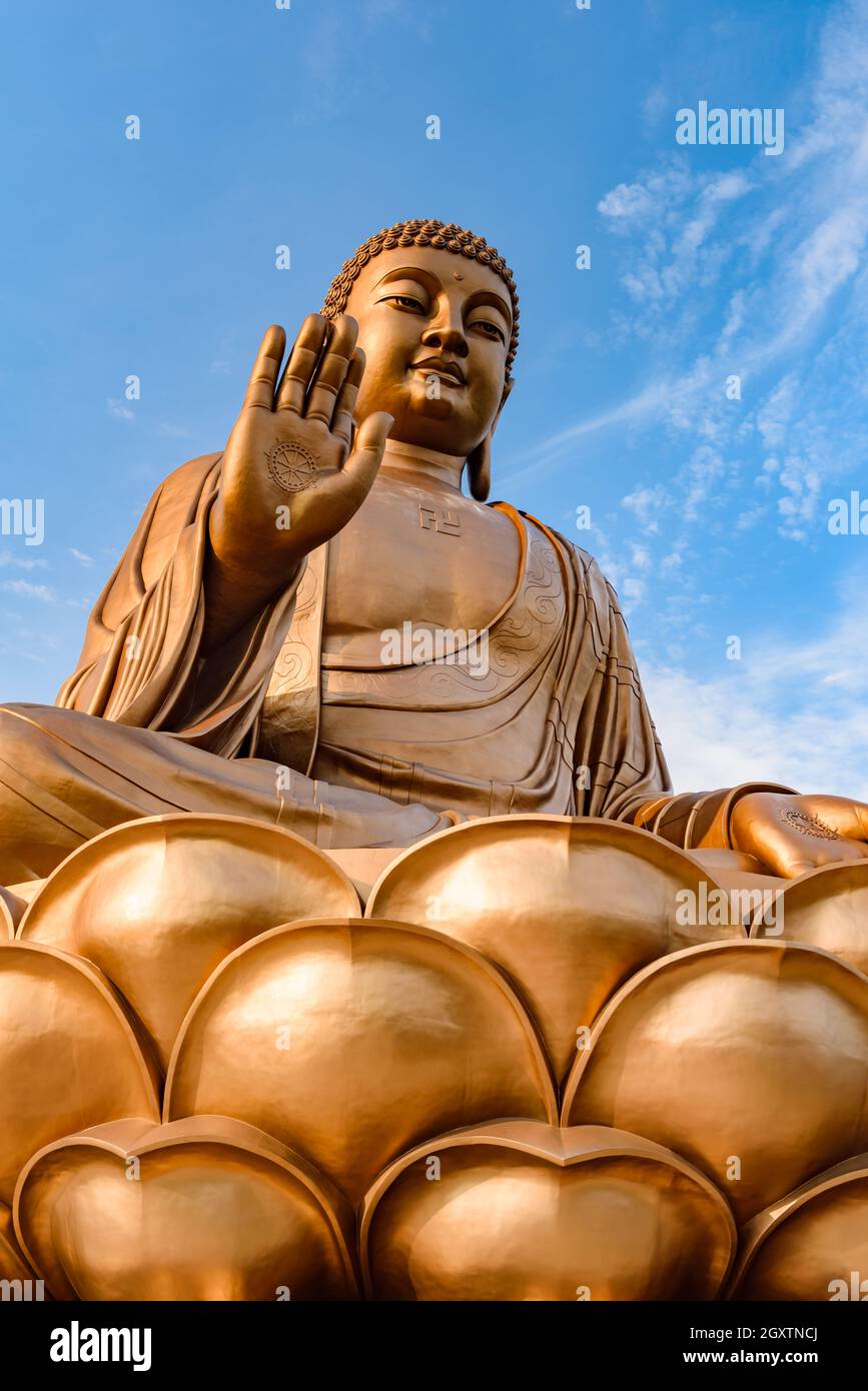 Giant Buddha statue with blue sky at Zhengjue Temple, Jilin, China Stock Photo