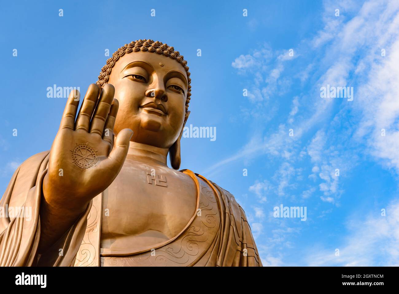 Giant Buddha statue with blue sky at Zhengjue Temple, Jilin, China Stock Photo