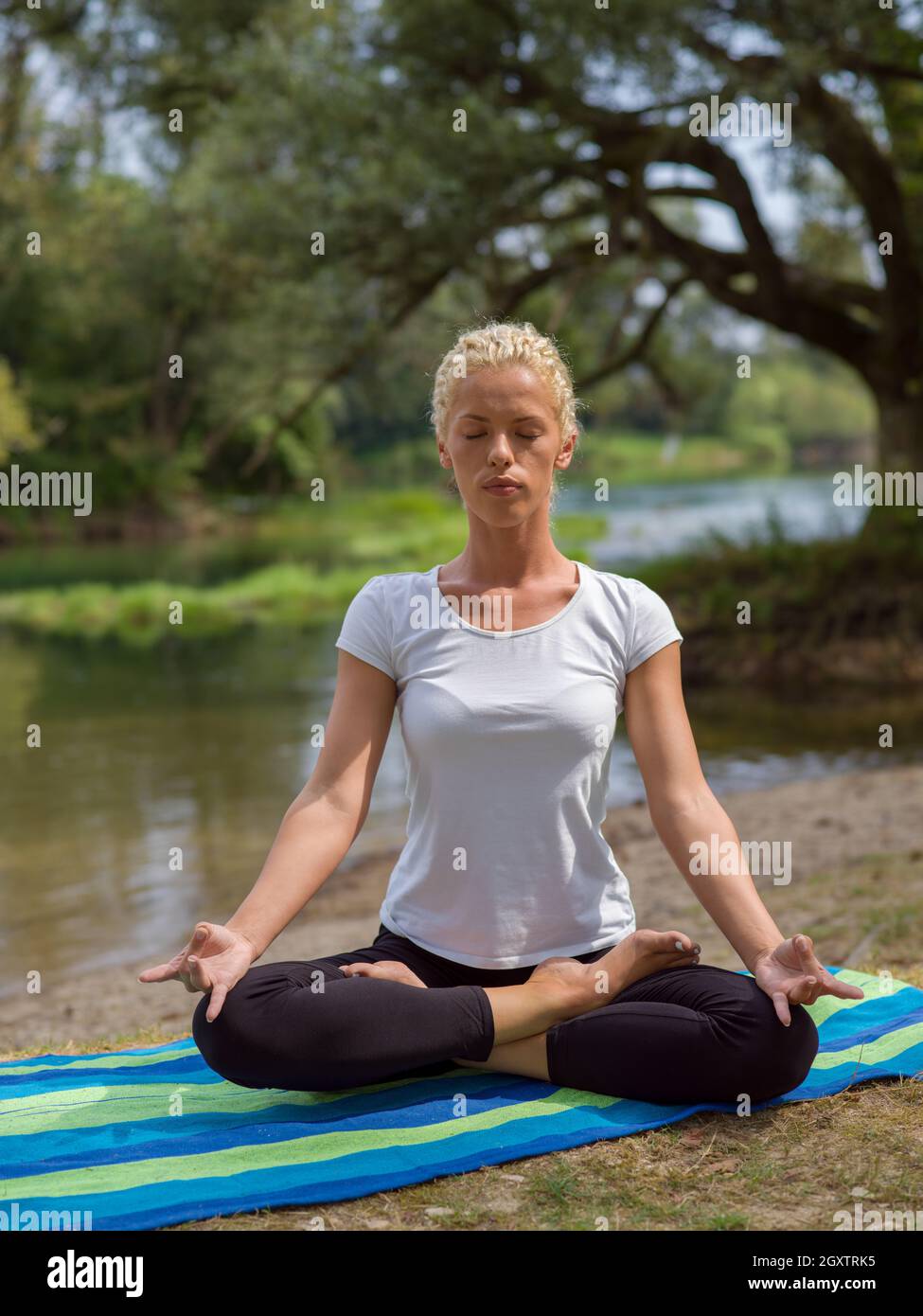 healthy woman relaxing while meditating and doing yoga exercise in