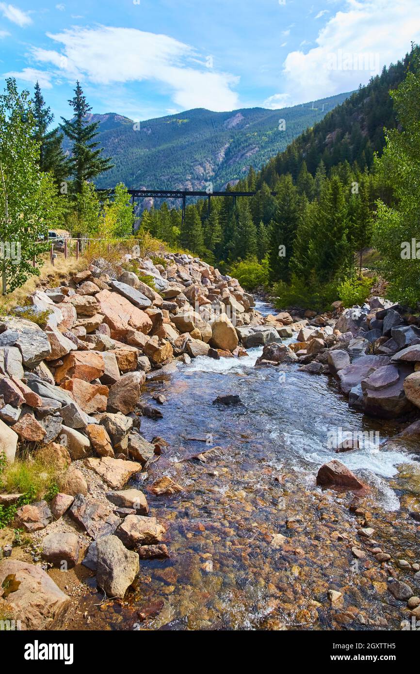 River through mountains in urban area Stock Photo