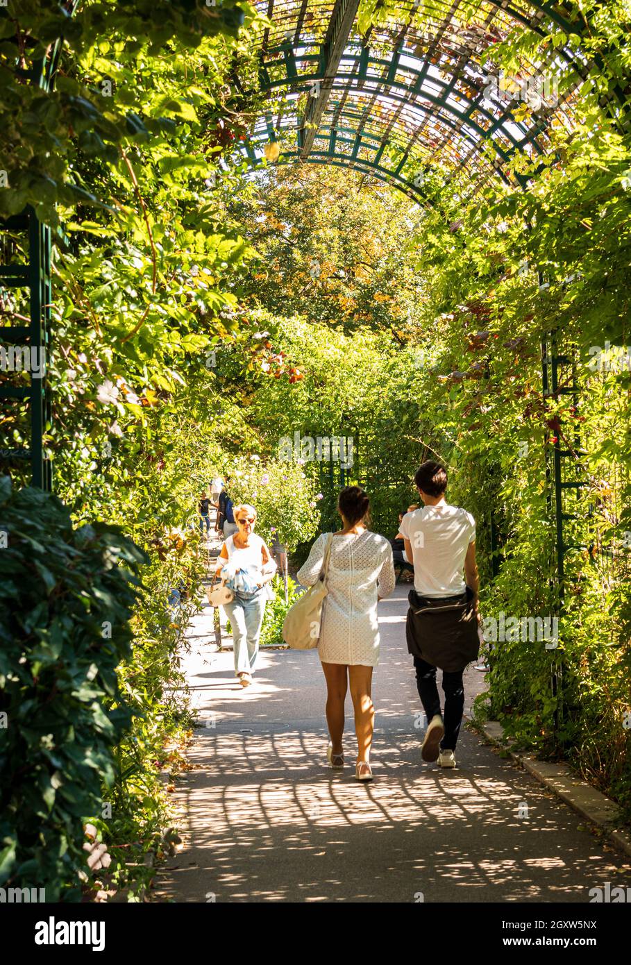 People walking on the Promenade Plantee in the 12th Arrondissement in Paris, France.  Sunny day, greenery, pleasant ambience. Stock Photo