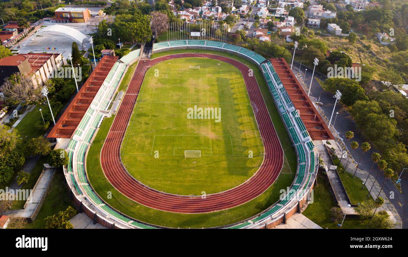 Aerial view of running track and soccer field surrounded by houses and
