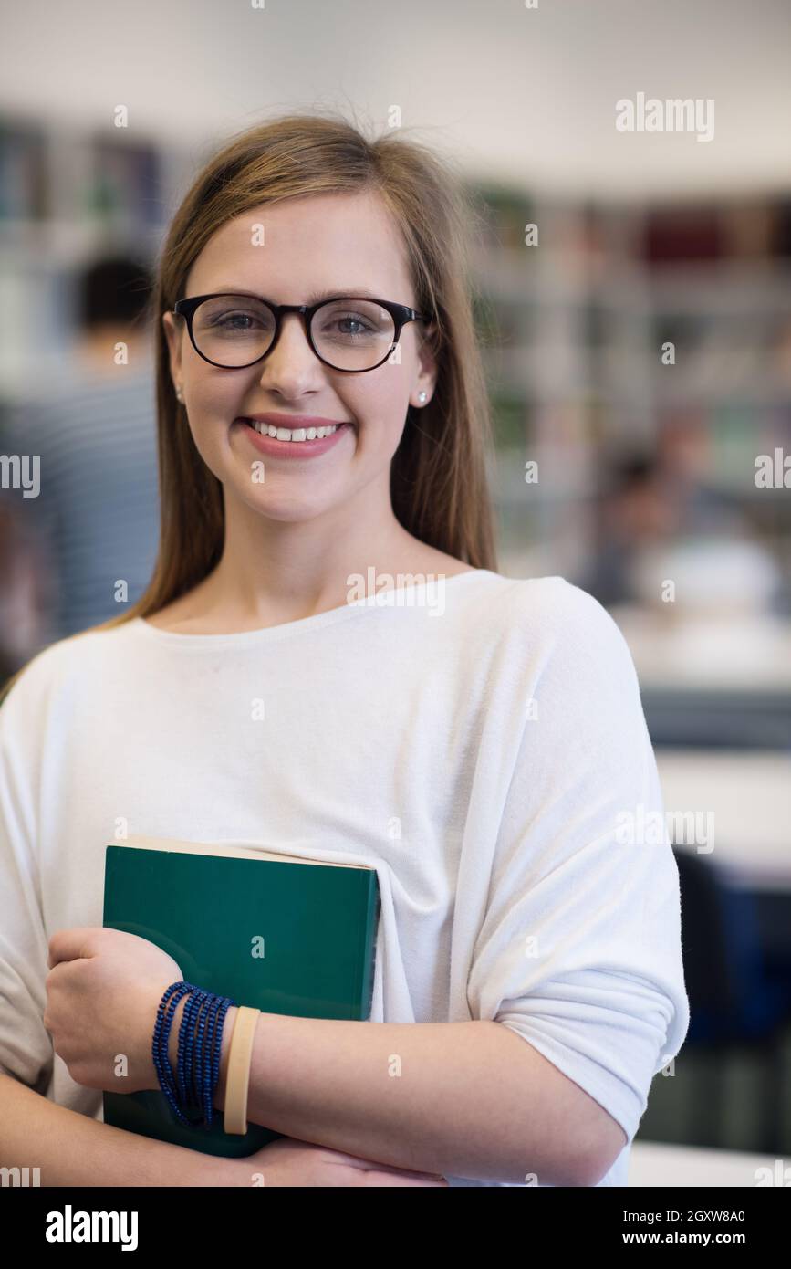 portrait of happy smilling female student girl in school library ...