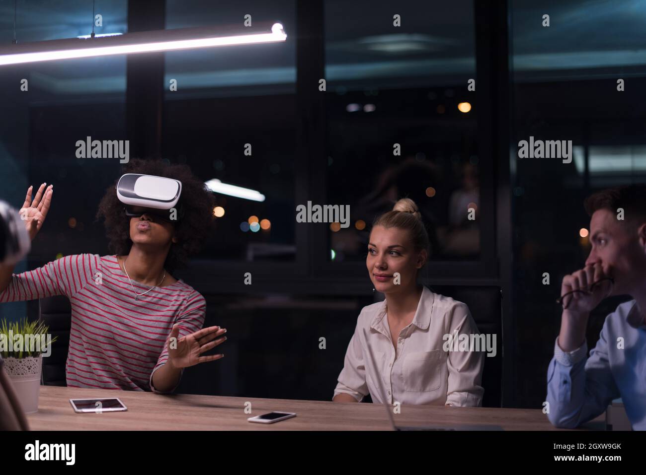 Meeting Simulation Multiethnic Business team using virtual reality headset in night office ...