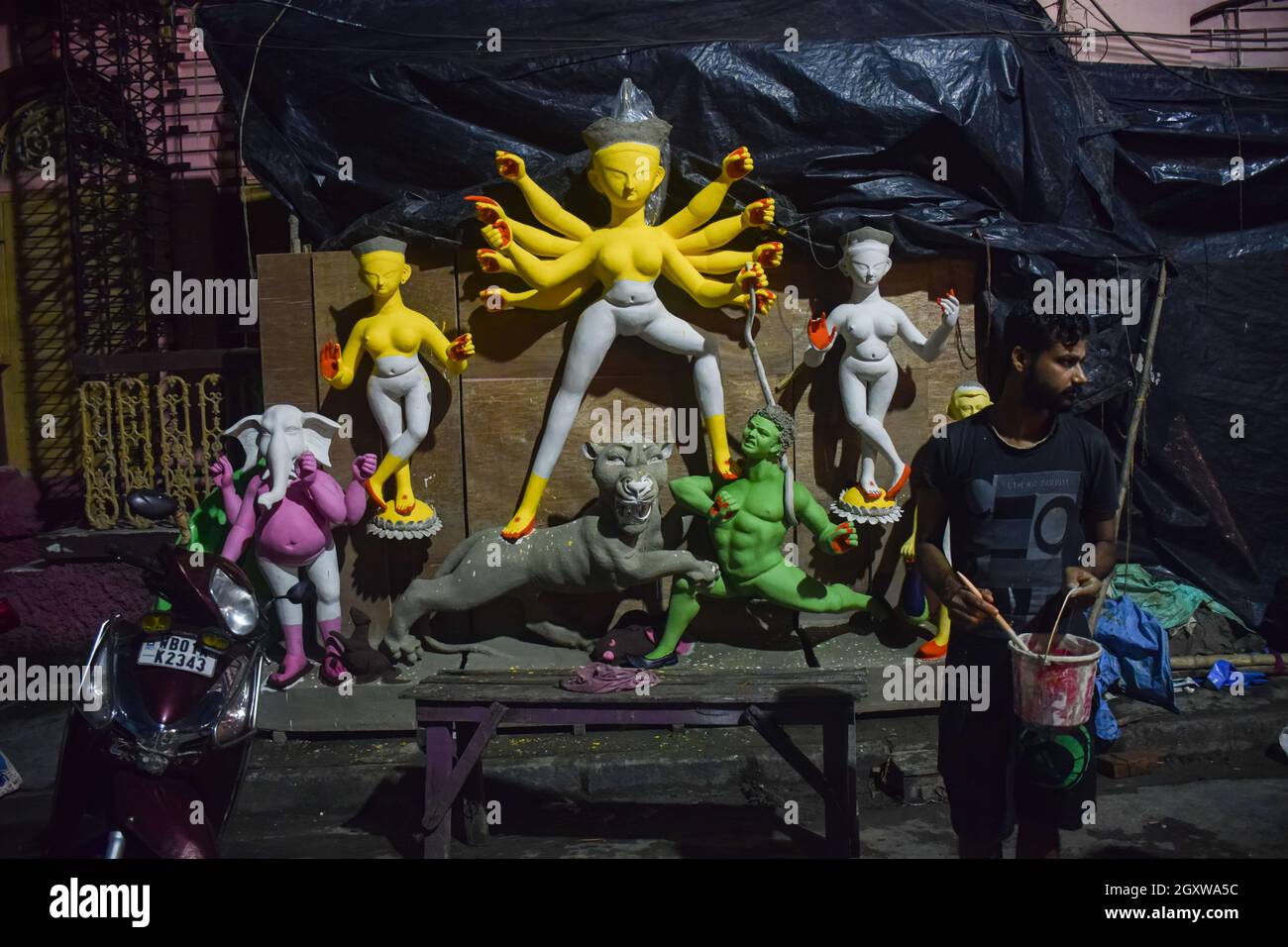 Kolkata, India. 05th Oct, 2021. An artist is seen coloring Durga idols.  Durga puja is one of the most popular festivals celebrated in West Bengal  and particularly in Kolkata, In honor of