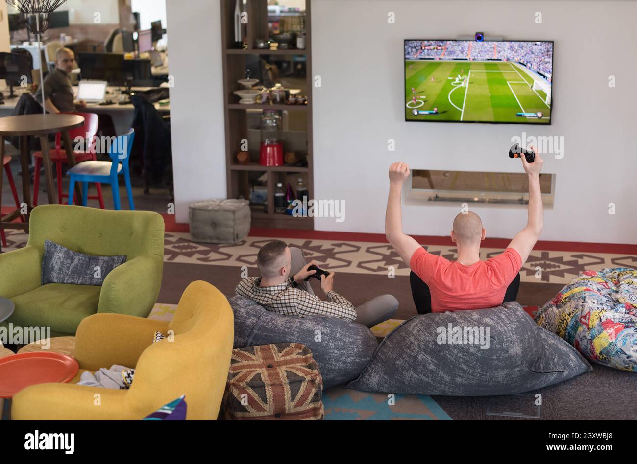 Work hard play hard. Workers Playing computer games in creative startup ...