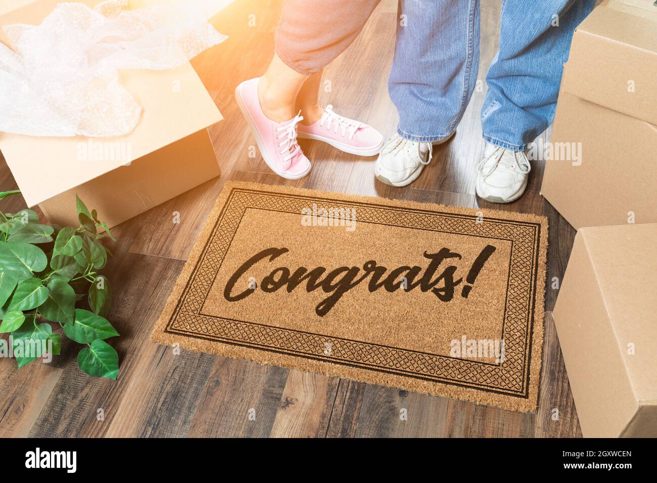 Man and Woman Unpacking Near Welcome Mat with Congrats, Moving Boxes ...