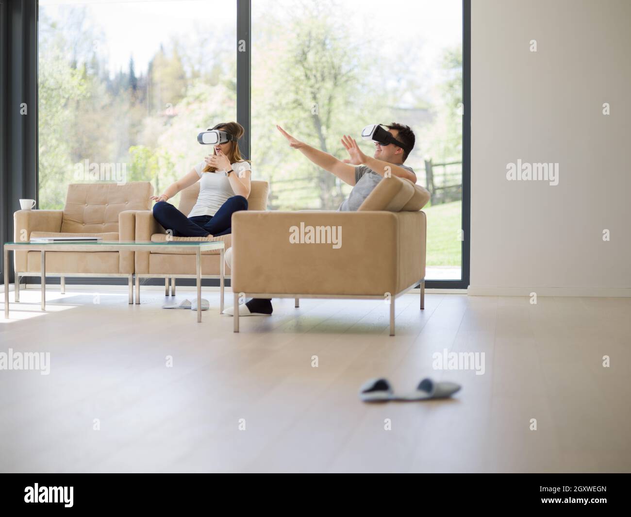 Couple using virtual reality headset in living room at home people ...