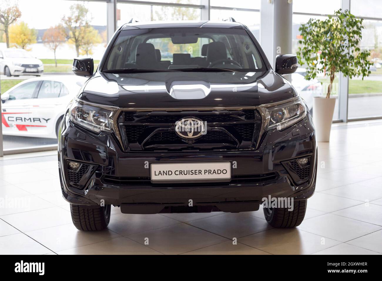 Russia, Izhevsk - September 30, 2021: Toyota showroom. New modern off-road Land Cruiser Prado in dealer showroom. Front view. Famous world brand. Stock Photo