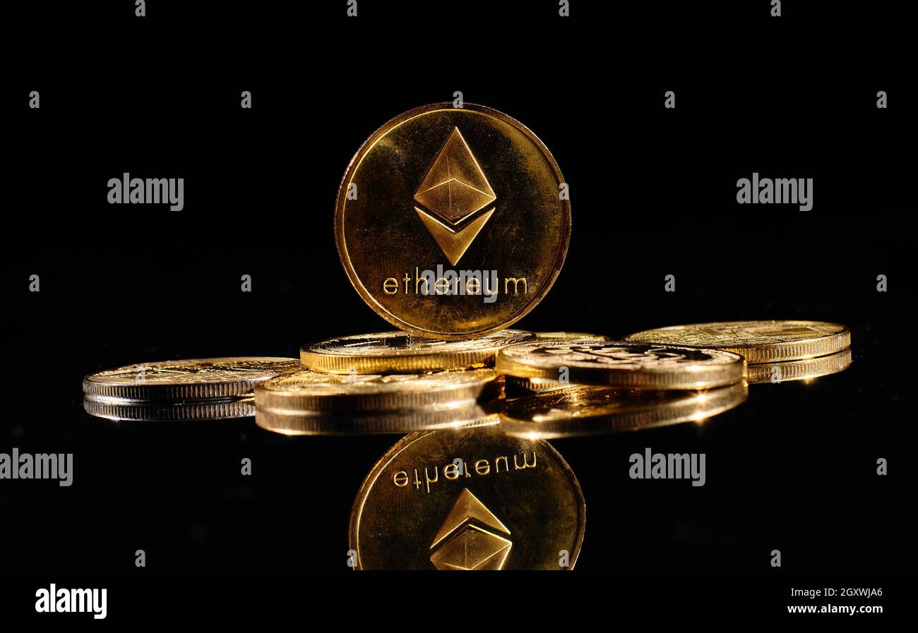 New cryptocurrency Ethereum ETH 2.0 on a top of bitcoin coins against black  background. Closeup golden coin with Ether logo. A heap of decentralized d  Stock Photo - Alamy