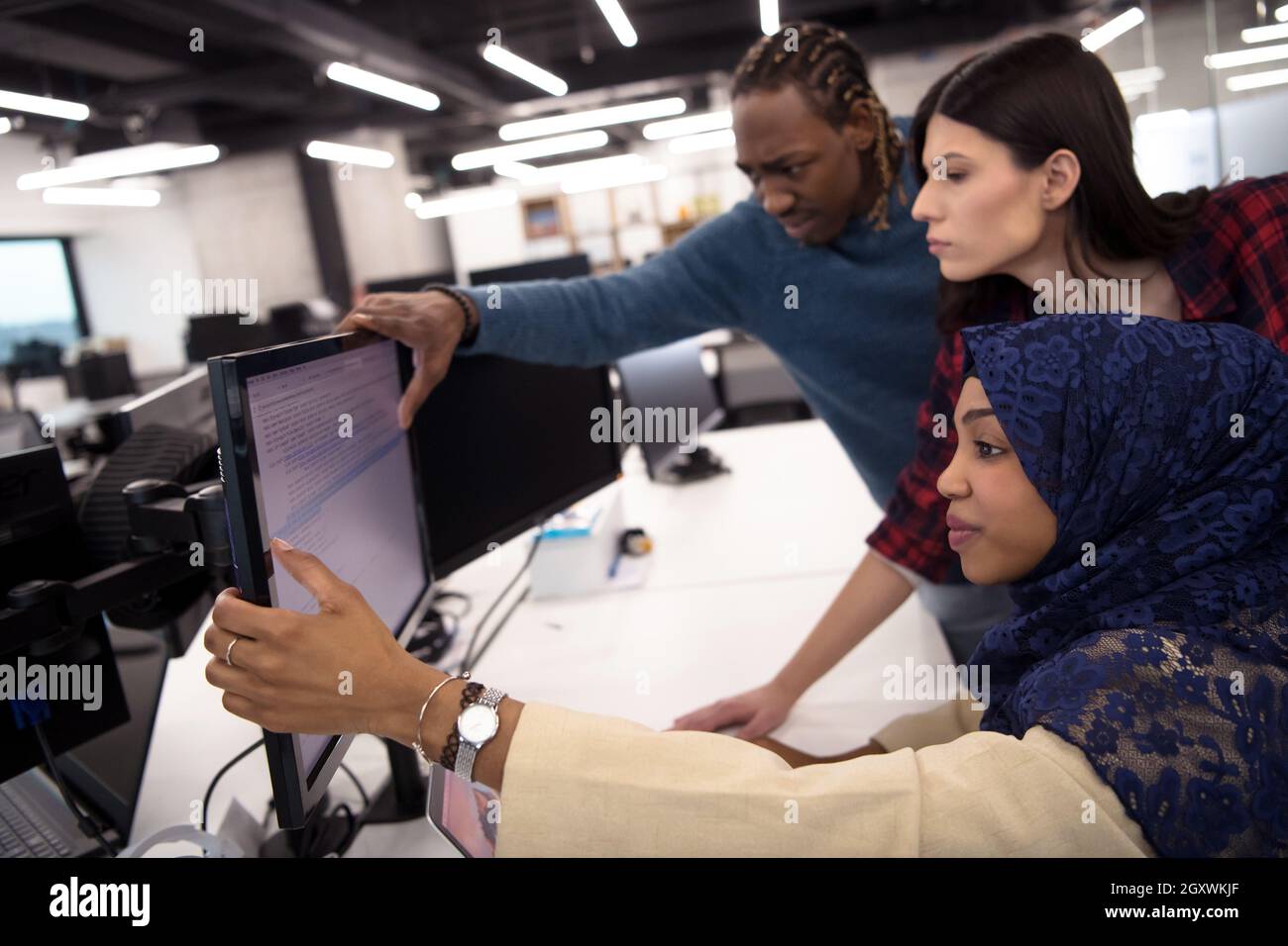 young multiethnics business team of software developers working ...