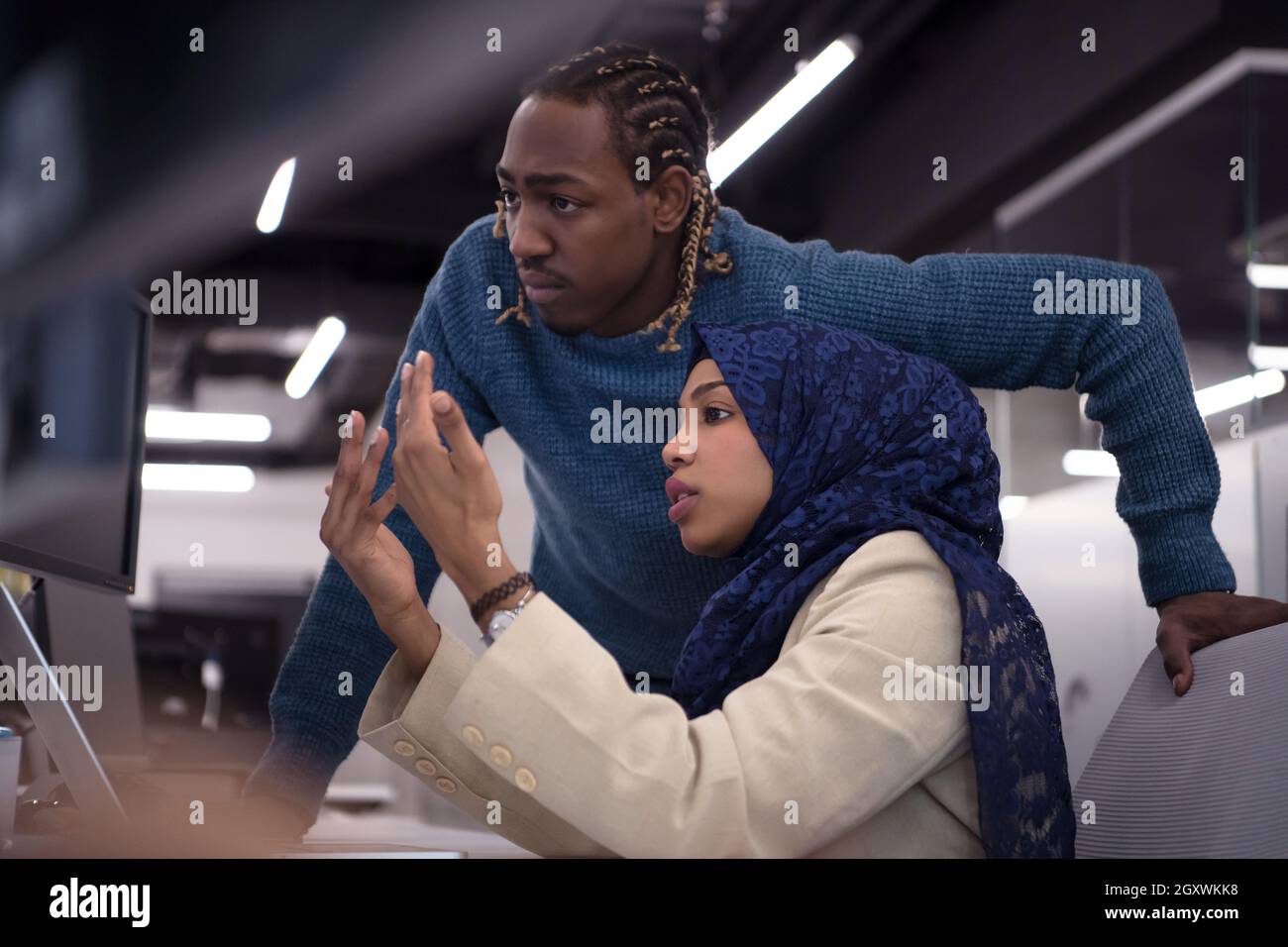 black muslim female software developer working together with her ...
