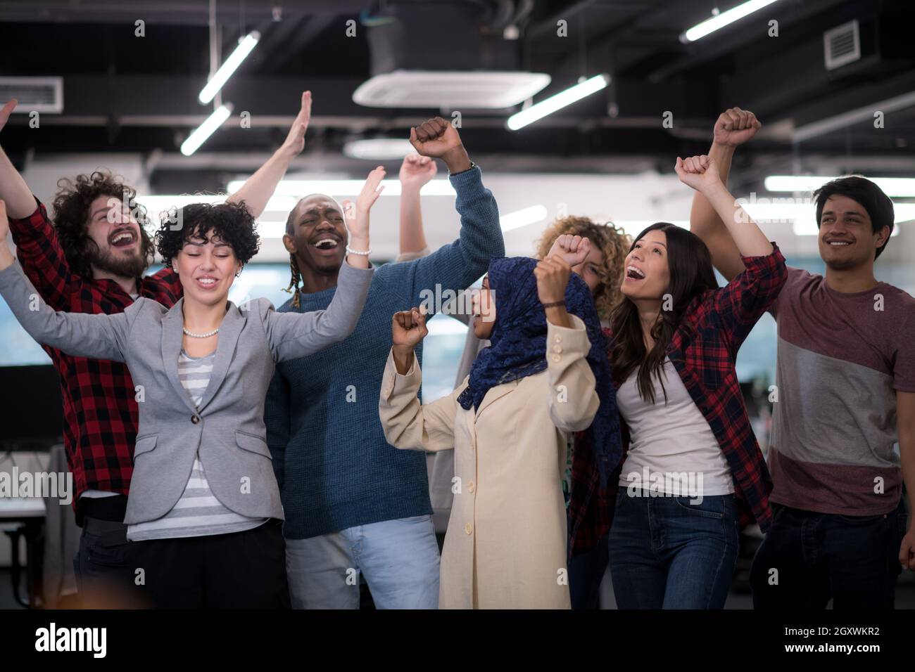 portrait of young excited multiethnics business team of software ...