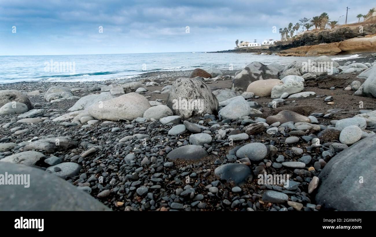Beautiful image of big rocks and boulders lying on sea beach at cloudy ...