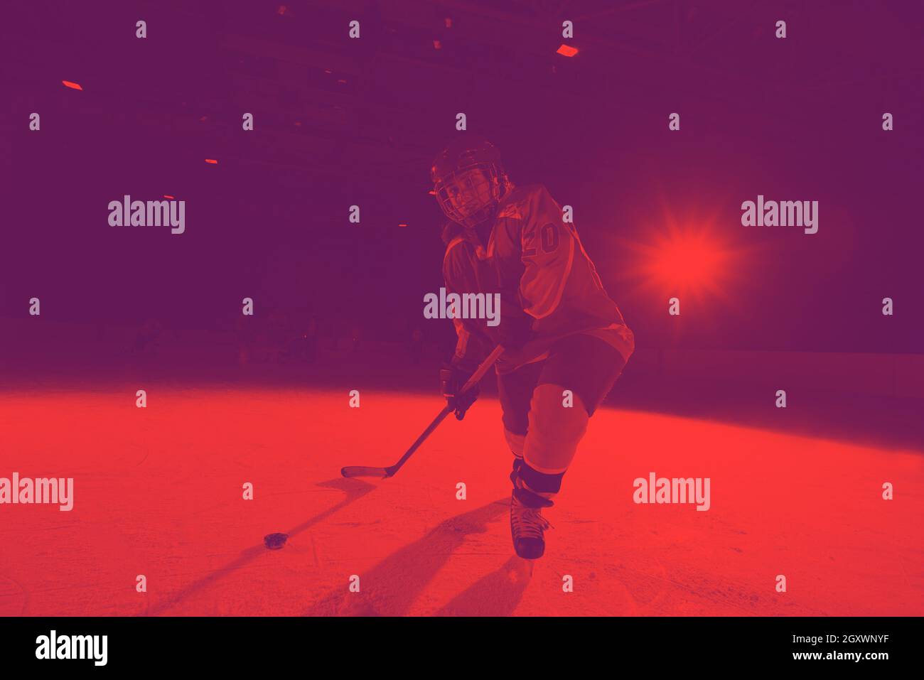 teen girl children ice hockey player in action kicking puck with stick