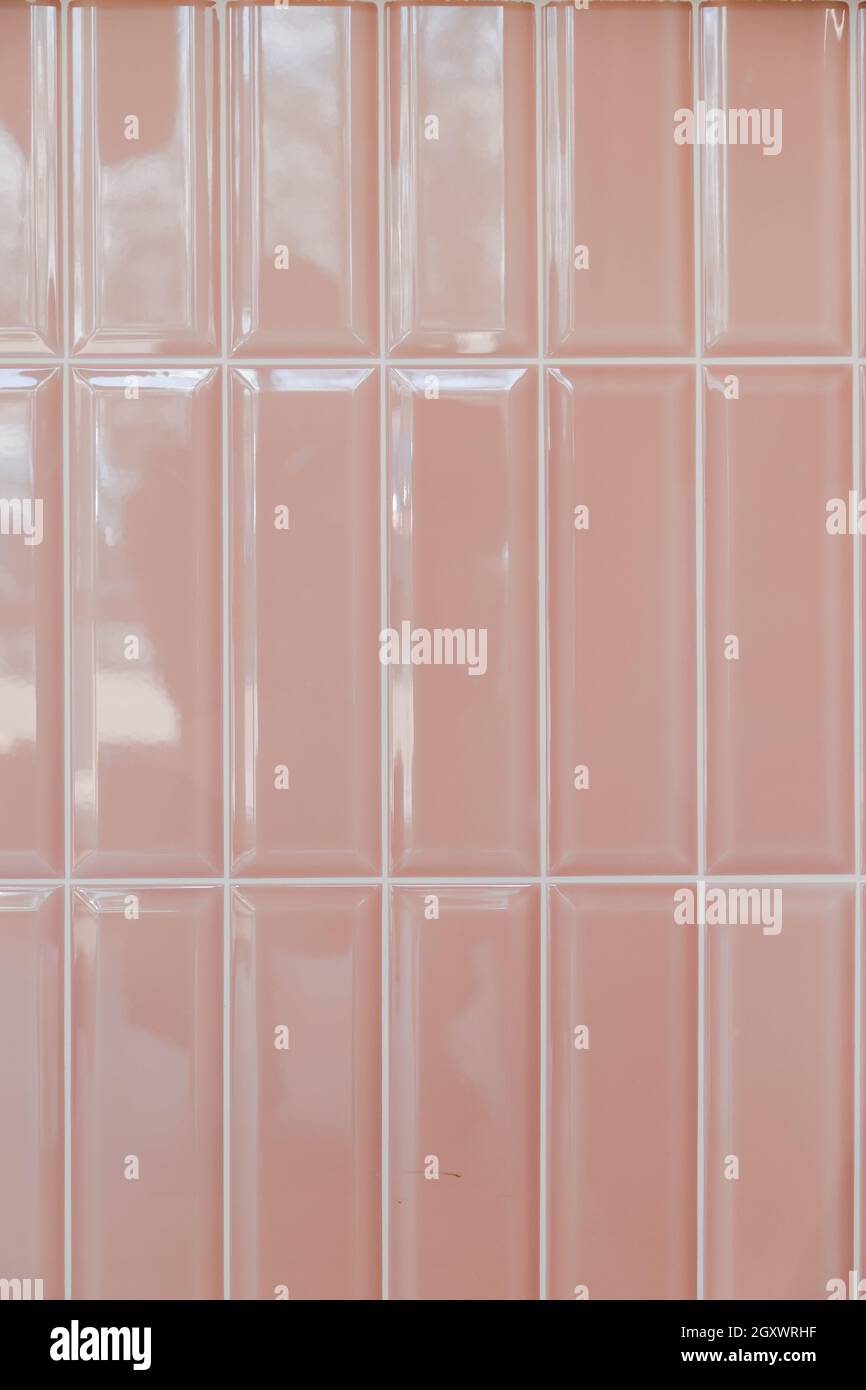 Pink glossy upright rectangular ceramic tile, background, texture. Stock Photo