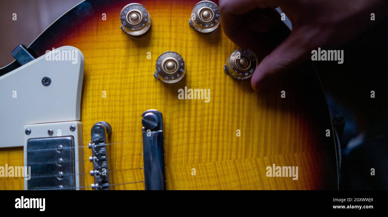 Volume controls and pickups of classic yellow electric guitar Stock Photo