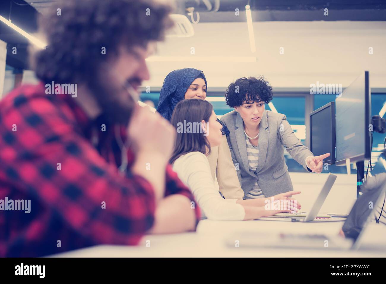 young multiethnics business team of software developers working ...