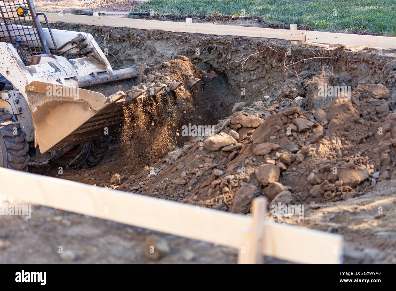 Small Bulldozer Digging In Yard For Pool Installation Stock Photo - Alamy
