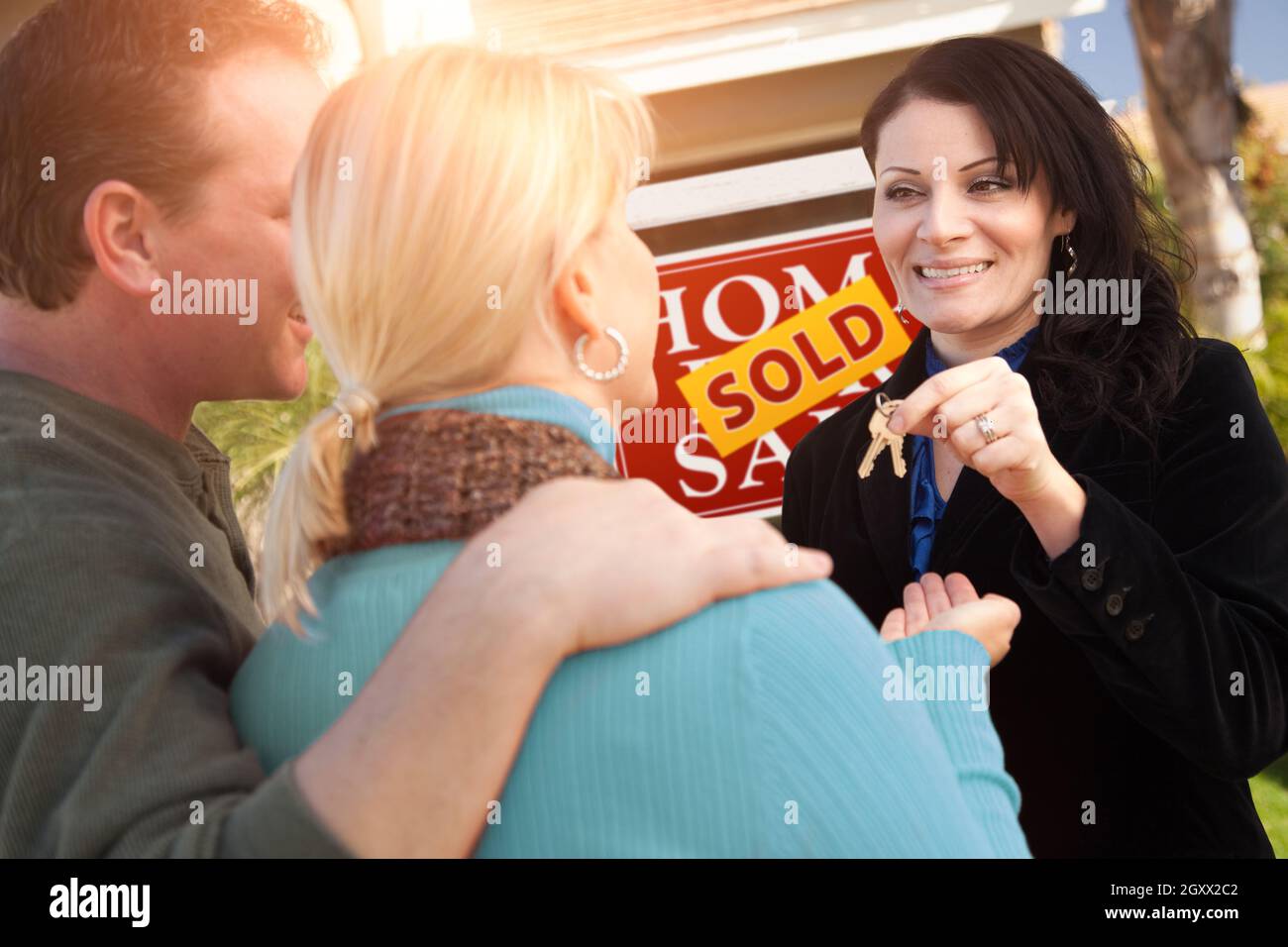 Hispanic Female Real Estate Agent Handing Over New House Keys to Happy ...