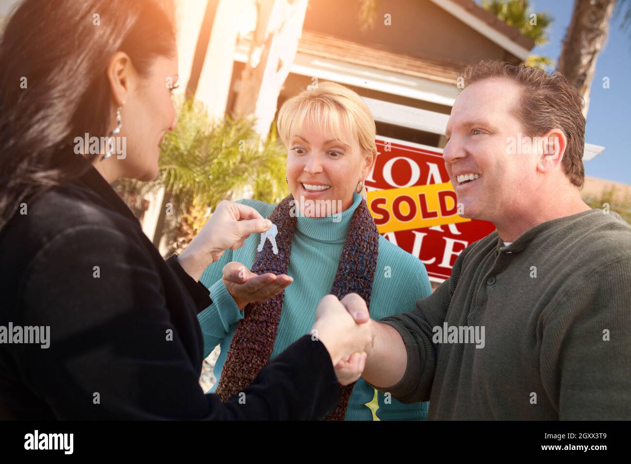 Hispanic Female Real Estate Agent Handing Over New House Keys to Happy ...