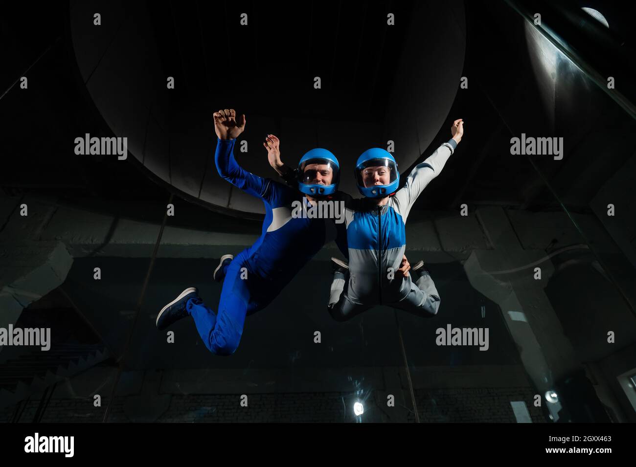 A man and a woman enjoy flying together in a wind tunnel. Free fall ...