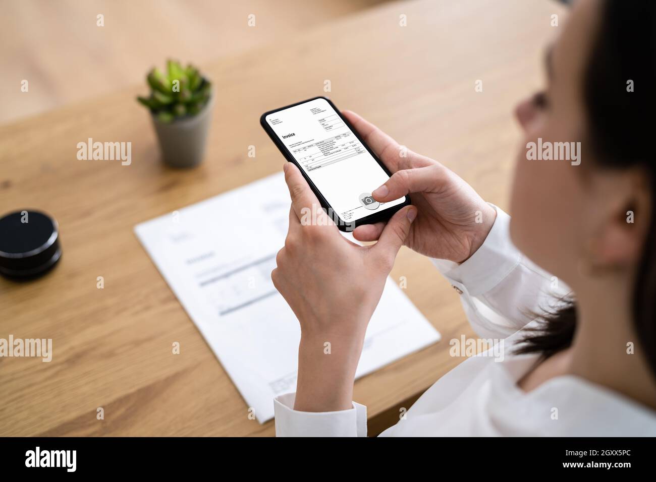 Taking Invoice Document Photo Using Phone Or Smartphone Stock Photo