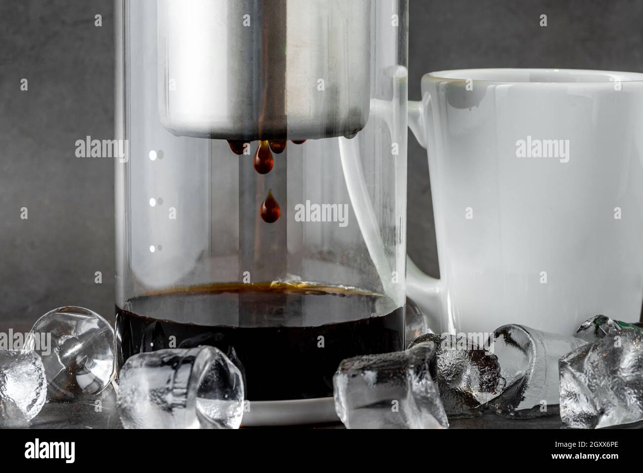 Modern Cold brew drip tower coffee maker on dark stone background Stock