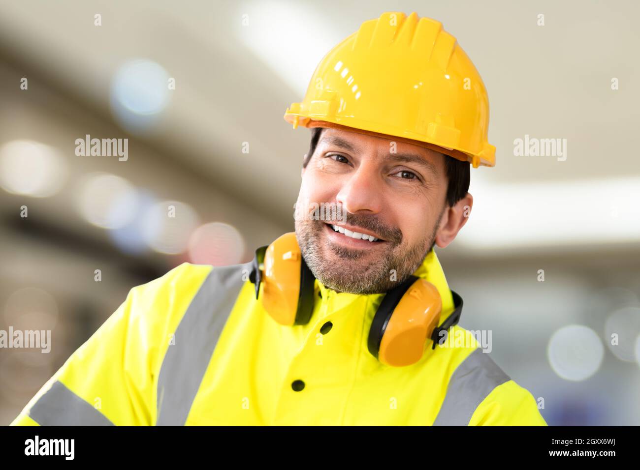 Young Worker Man With Hard Hat At Work Stock Photo