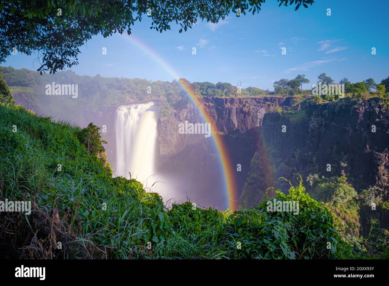 Victoria Falls first Gorge waterfall with rainbow. Victoria Falls National Park, Zimbabwe, Africa Stock Photo