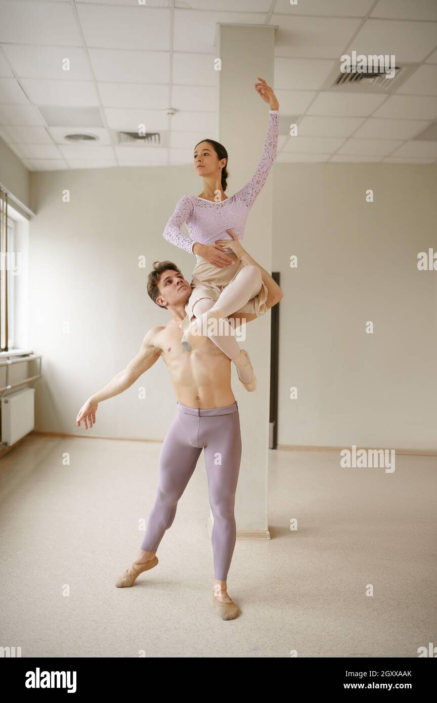 Couple of ballet dancers, dancing in action. Ballerina with partner ...