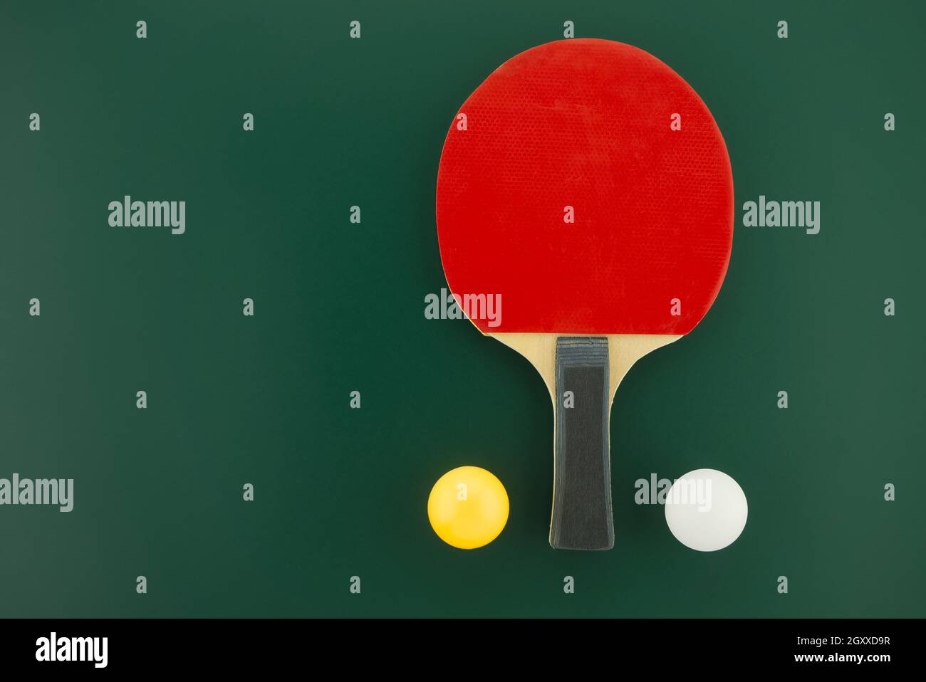 Table tennis equipment, racks and balls on green background with free