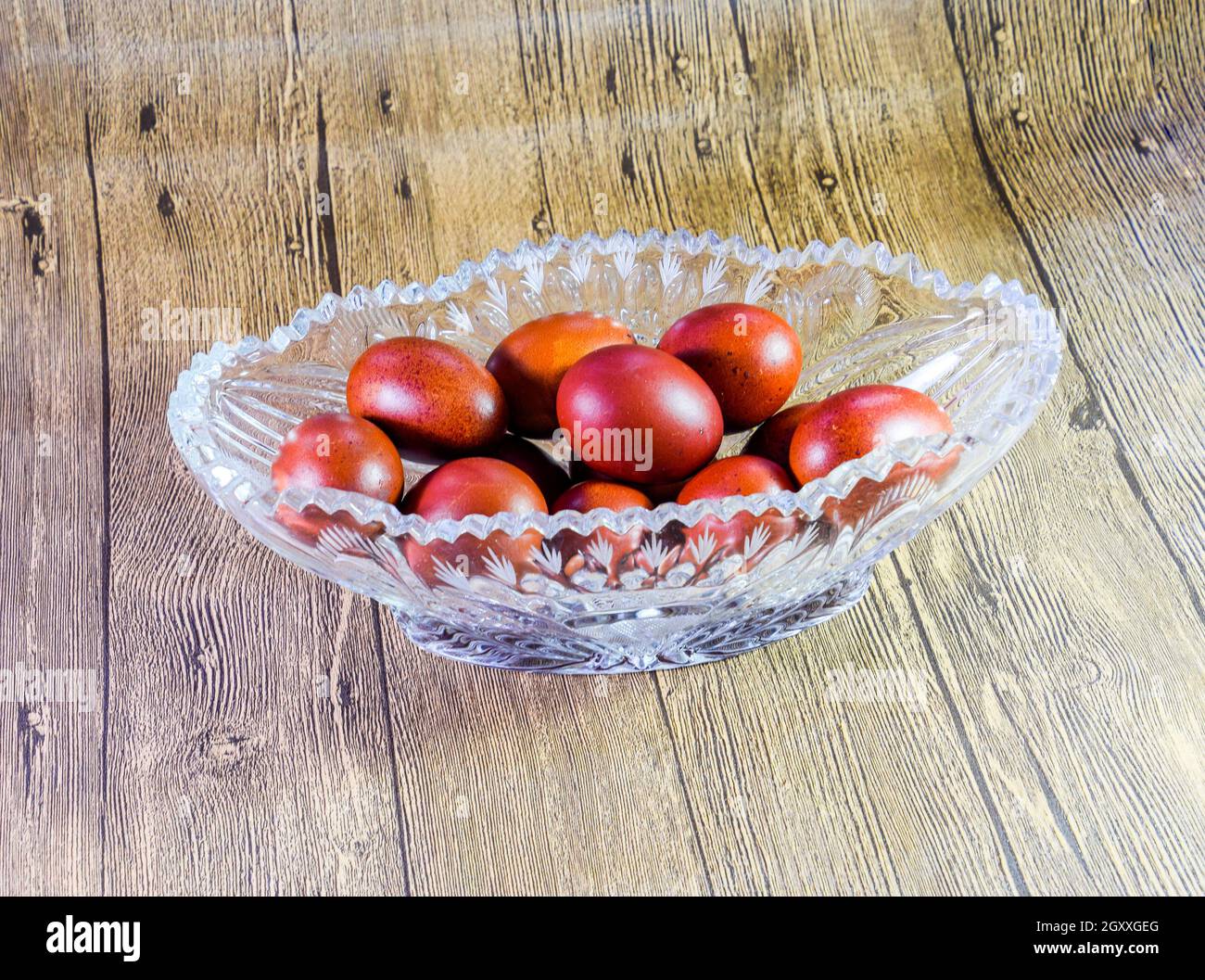 Painted Easter eggs in a crystal vase. Red painted chicken eggs for easter. Stock Photo