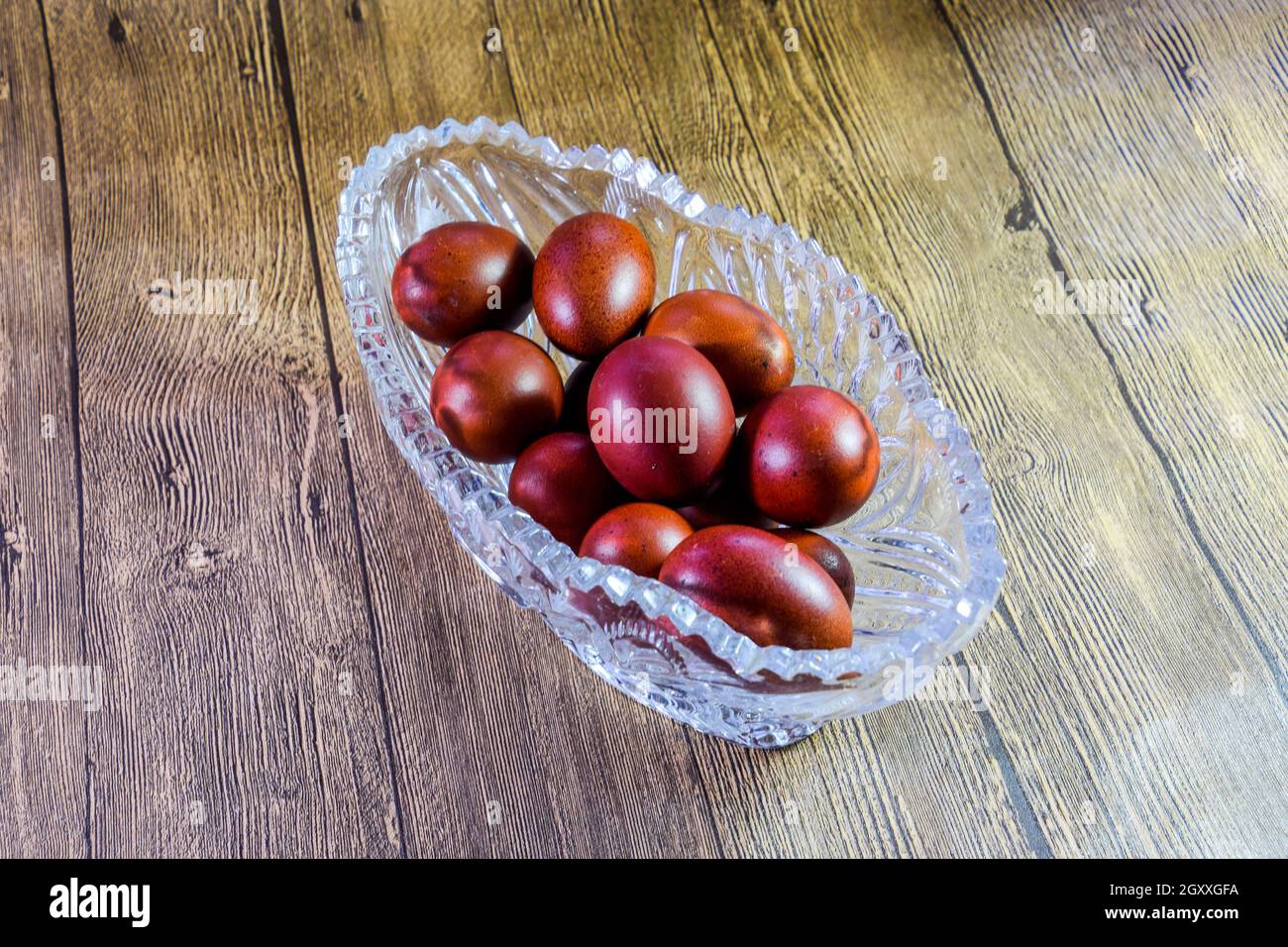 Painted Easter eggs in a crystal vase. Red painted chicken eggs for easter. Stock Photo