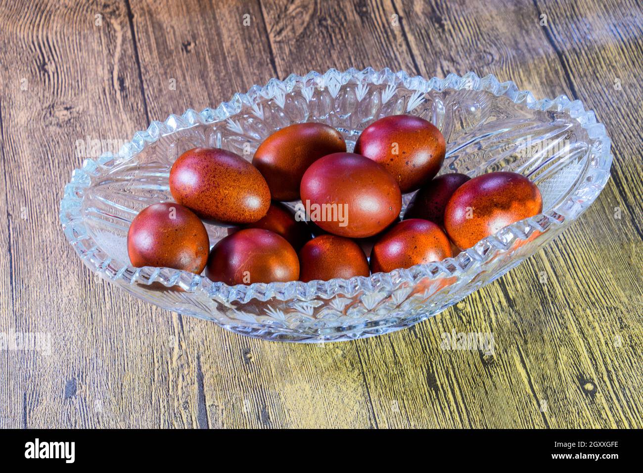 Painted Easter eggs in a crystal vase. Red painted chicken eggs for easter. Stock Photo
