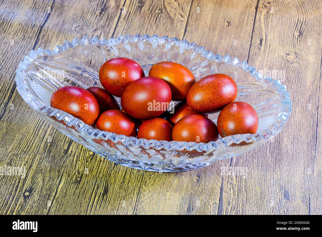 Painted Easter eggs in a crystal vase. Red painted chicken eggs for easter. Stock Photo