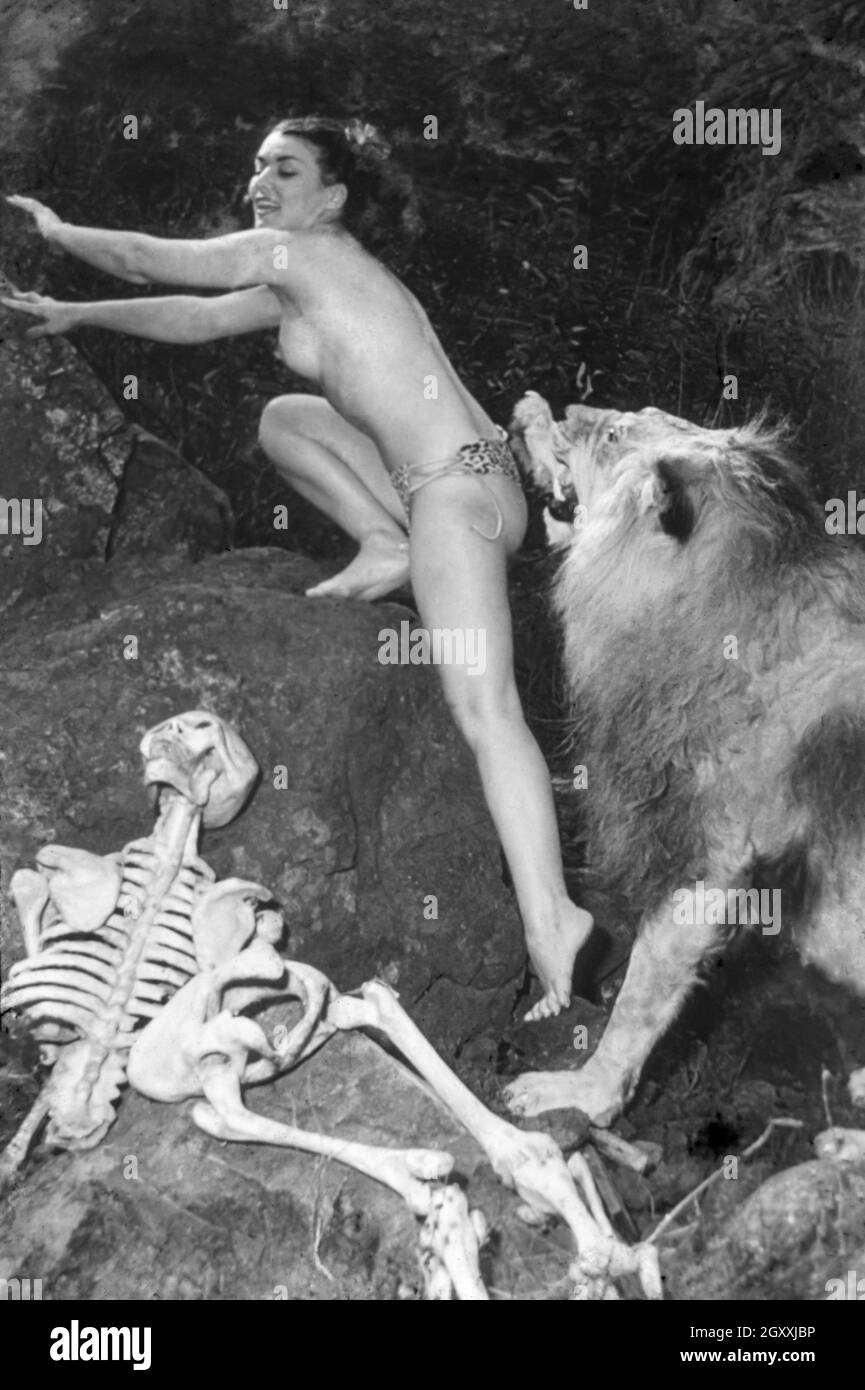 Vintage 1950s / 1940s nude glamour model escaping a lion Stock Photo