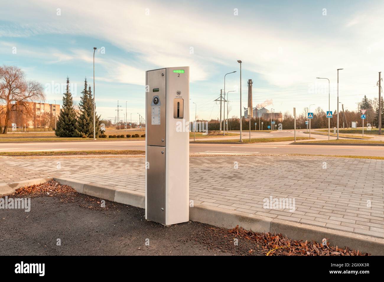 Small electro car charging station on the parking . Electric car charging battery. Alternative environmental energy for car. Environmental protection. Stock Photo