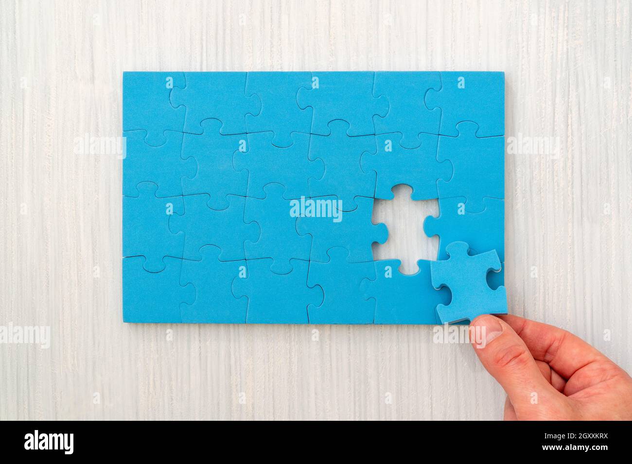 Hand put the last piece of jigsaw puzzle to complete the mission Stock  Photo - Alamy