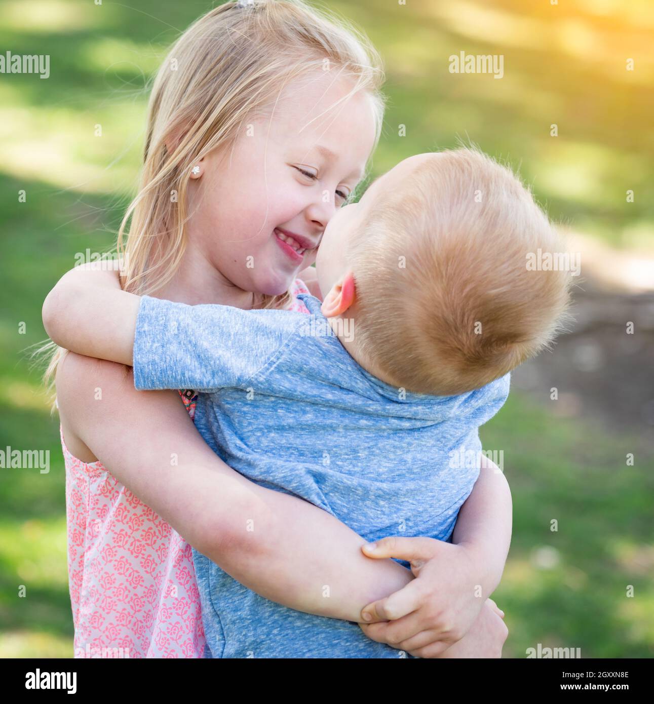 Young Brother and Sister Hugging At The Park Stock Photo - Alamy