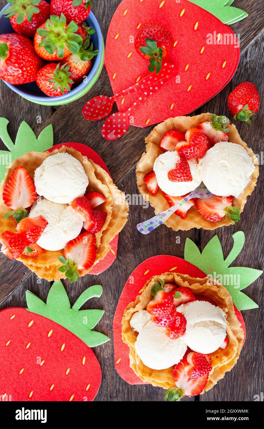 Vanilla ice cream with fresh strawberries in waffle cups Stock Photo