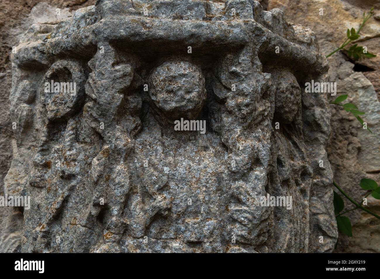 Close-up of a deteriorated stone capital suggesting a human form. Hermitage of Sant Honorat, island of Mallorca, Spain Stock Photo