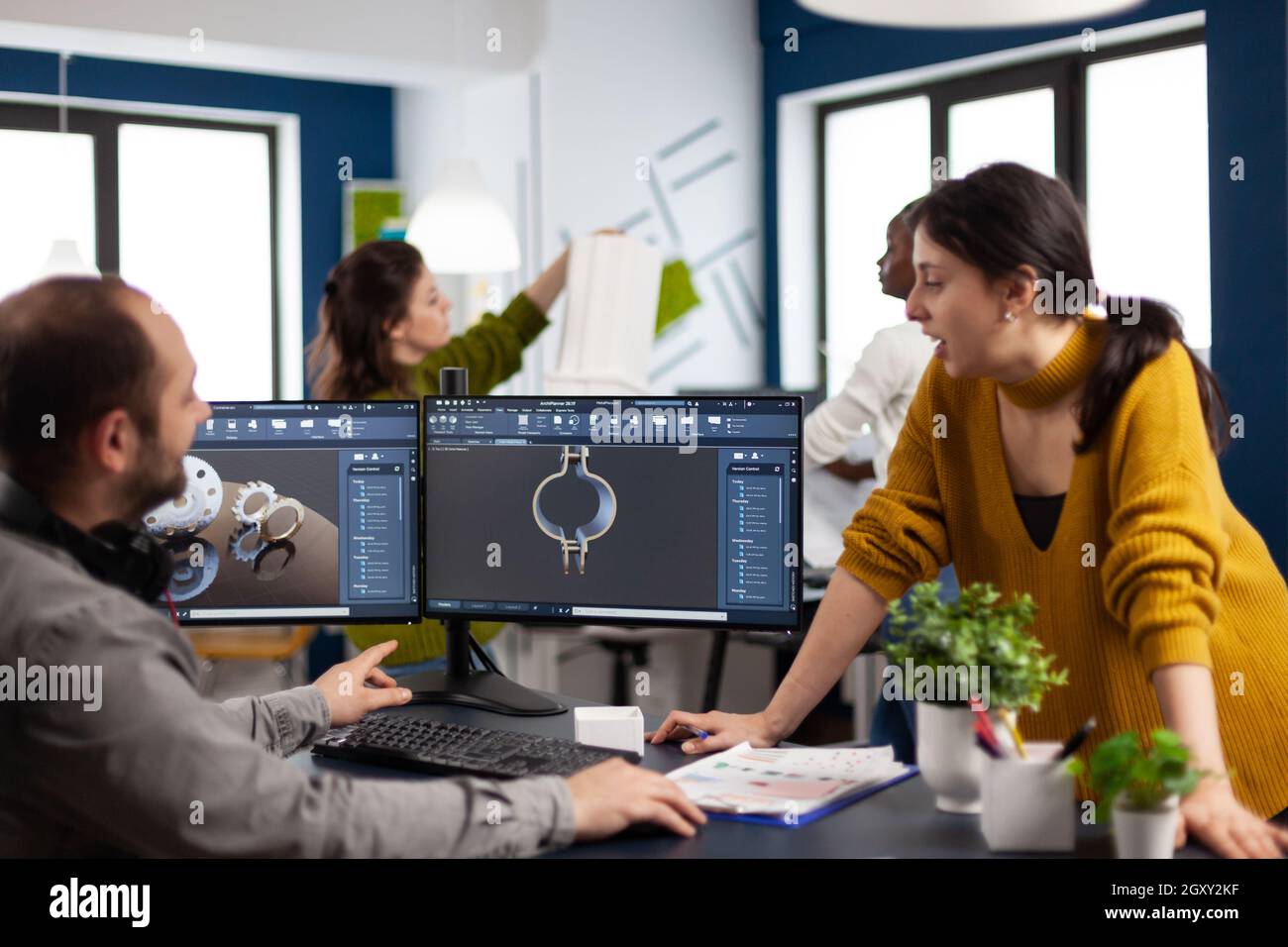 Coworkers engineer working on modern cad program developing industrial ...