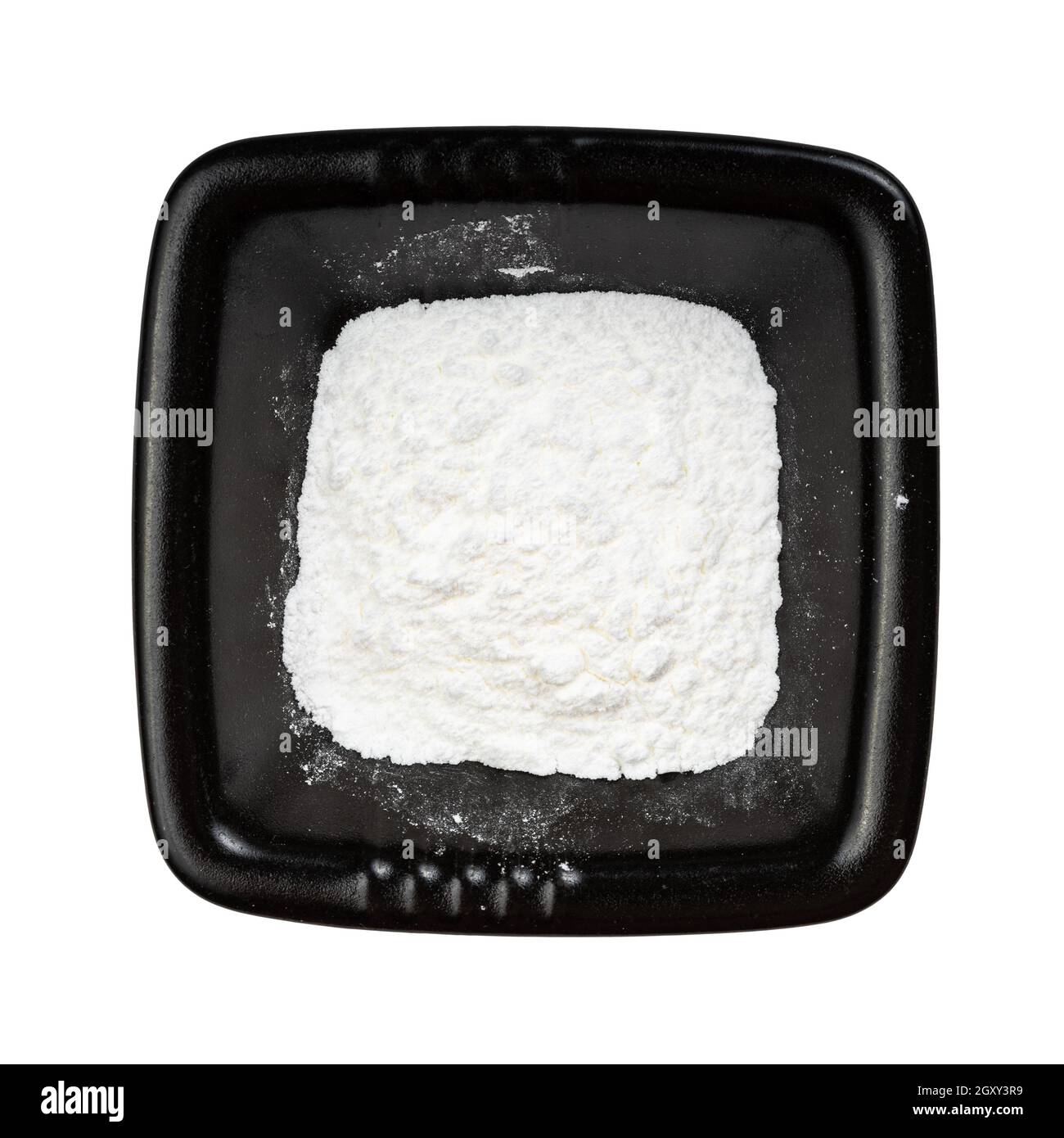 top view of baking powder in black bowl isolated on white background Stock Photo